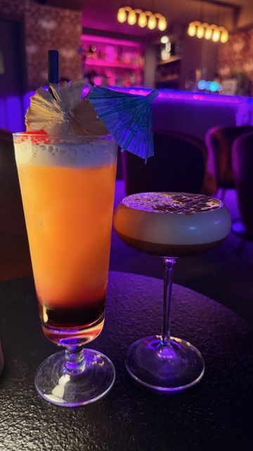 Two cocktails in the neon-lit cocktail lounge