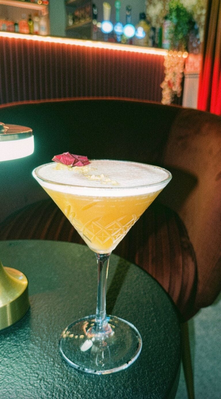 Signature cocktail in a cut-glass martini glass